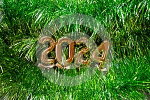 New Year 2024 - Orange old gold numbers on light green glitter grass background