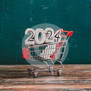 New year 2024 in shopping trolley, online shopping concept