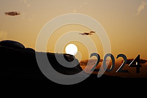 New Year 2024 with Silhouette and sunset background.