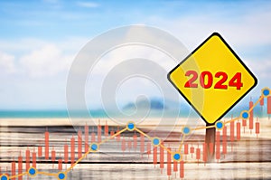 New year 2024 written on yellow sign with growth graph