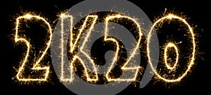 New Year 2K20 made by sparkler . Text 2K20 written sparkling sparklers . Isolated on a black background . Overlay template for