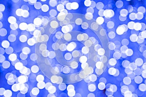 New year background. Abstract pattern of blue bokeh lights on a dark. Night festive bokeh city blurred backdrop.