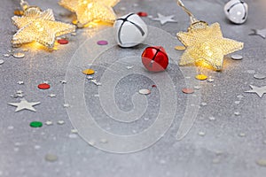 New year background with copy space. glowing holiday lights, jingle bells and star confetti