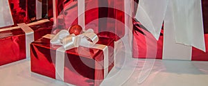 New year banner, horizontal background, red holiday gift boxes decorated with white ribbon, on a white background