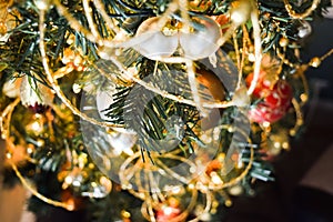 New Year baubles on decorated Christmas Tree with blurred background