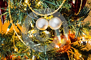 New Year baubles on decorated Christmas Tree with blurred background