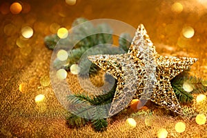 New Year card. Christmas greetings. Golden decorative star with Christmas tree branches, on golden background.