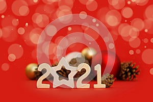 New Year card. Christmas mockup with fir cones, new year balls, candy cane, numbers 2021, bokeh on red background with place for