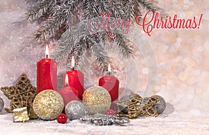 New Year card. Christmas red candles in light Christmas decoration, a wreath of fir branches, glass balls and stars on a light bac