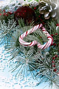 New year card, red ball with a lollipops, christmas tree branch and pine cone wallpaper on a white background , vertical