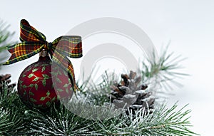 new year card, red ball with a pattern, christmas tree branch and pine cone wallpaper on a white background , horizontal