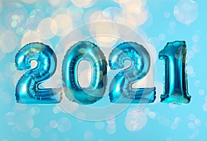 2021 New Year celebration. Bright balloons and blurred lights on blue background