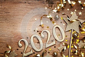 New Year celebration and festive background with golden numbers 2020, confetti stars and Christmas decorations top view