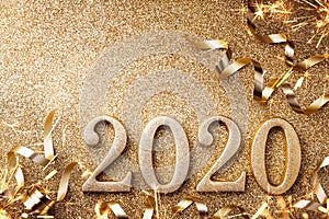 New Year celebration and festive background with golden numbers 2020, streamers and Christmas decorations top view