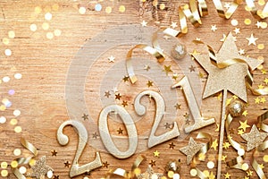New Year celebration and festive background with golden numbers 2021, confetti stars and Christmas decorations top view