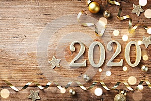 New Year celebration and festive background with golden numbers 2020, confetti stars and Christmas decorations top view