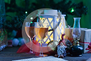 new year celebration - two glasses with pink wine near christmas tree. Christmas tree branch