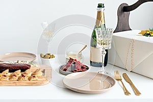 New Year champagne and vintage french glasses. Food for Christmas selebration. Happy winter holidays. Presents for