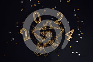 New Year, Christmas background. Golden candle numbers 2024 on a black background with golden sequins