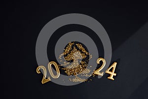 New Year, Christmas background. Golden candles numbers 2024on a black background with golden sequins