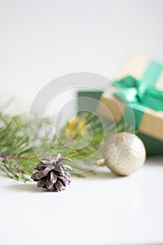 New Year and Christmas background. Pine branches, Christmas balls, pine cone and gift box