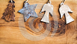 New Year or Christmas background: wooden angels, star and fir-tree over rustic backdrop, copy space