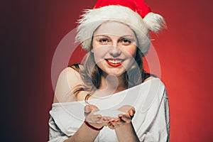 New Year Christmas cap woman portrait on red background