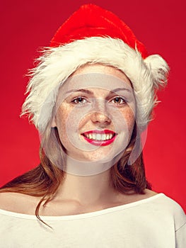 New Year Christmas cap woman portrait on red background