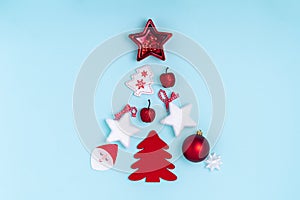 New Year and Christmas composition in the form of chrismas tree. Red and white decorations - stars, christmas balls, toys on