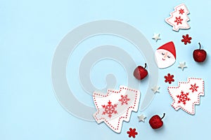 New Year and Christmas composition. Frame frome red and white christmas toys on blue background. Top view, flat lay, copy space