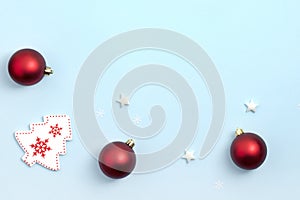 New Year and Christmas composition. Frame frome red and white christmas toys on blue background. Top view, flat lay, copy space