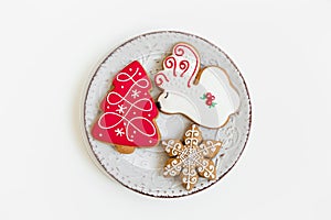 New year and christmas composition. gingerbread cookies on the plate. deer and tree shaped. white background