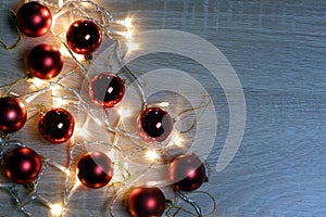New year christmas composition from red shiny and matte balls on light wood background copy space