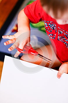 New Year/Christmas concept - a boy cutting paper snoflakes