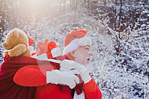 New year Christmas concept. Santa Claus pulling huge bag of gifts on white nature background. Santa Claus coming to the