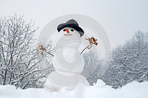 New year Christmas concept. Snowman outdoor. Happy smiling snow man on sunny winter day. Cute little snowman outdoor