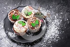 New Year and Christmas cupcake or muffin on dark stone background. 2022 celebration, festive food. Seasonal winter Holidays.