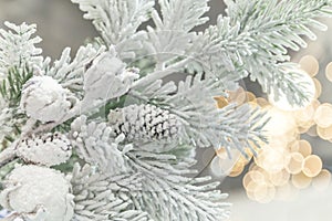 New Year and Christmas decor. Festive background with decorative artificial shining snow-covered branches of Christmas trees in