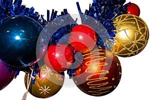 New Year and Christmas decoration balls closeup view on isolated background. Golden, blue and red balls with blue decorative