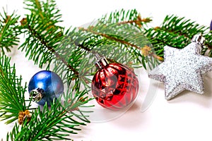 New Year and Christmas decoration with green fir tree branches and blue and silver shiny xmas traditional balls and baubles