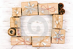 New Year and Christmas Frame Composition. handmade wrapped christmas gift boxes with decoration on white background with empty