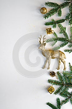 New year or Christmas frame is made of Christmas decorations, balls, gold beads, gifts, lights and fir branches on a white backgro
