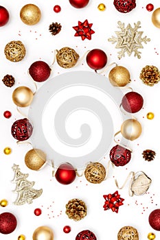 New Year and Christmas frame. Red and golden Christmas decorations - shiny balls, stars, pine cones and decorative ribbon on white