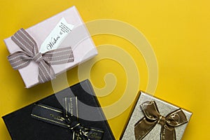 New Year and Christmas gift boxes concepts, and Realistic gifts boxes on yellow background, set of three gift boxes on top view