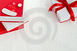 New Year or Christmas greeting card decorated white gift with red boxes with ribbons.