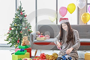 New Year, Christmas and Holiday Seasoning concept.  Portrait of young asian Thai girl woman using scissors to make and decorate