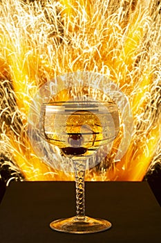 New Year and Christmas image of champagne glass on blast of sparks background