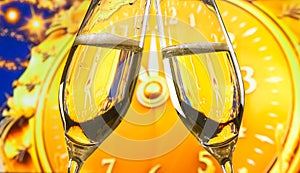 New Year or Christmas at midnight with champagne flutes make cheers on golden clock background