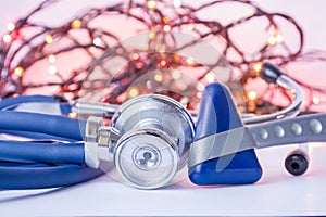 New Year and Christmas in neurology, internal medicine, general practice. Medical stethoscope and neurological reflex hummer in fo photo