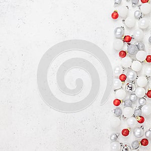 New Year or Christmas pattern flat lay top view Xmas holiday celebration decorative toy balls sparkles white concrete background